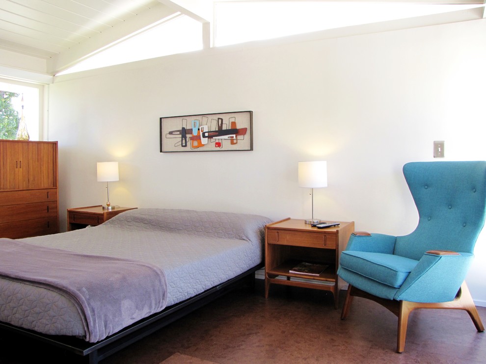 Photo of a midcentury bedroom in Orange County with white walls and cork floors.