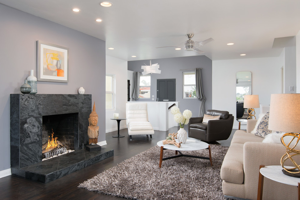 Inspiration for a contemporary open concept living room in San Diego with grey walls, dark hardwood floors, a standard fireplace and a stone fireplace surround.