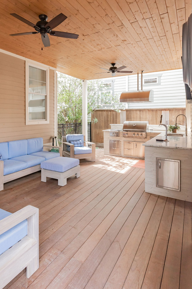 Design ideas for a transitional deck in Houston with an outdoor kitchen and a roof extension.