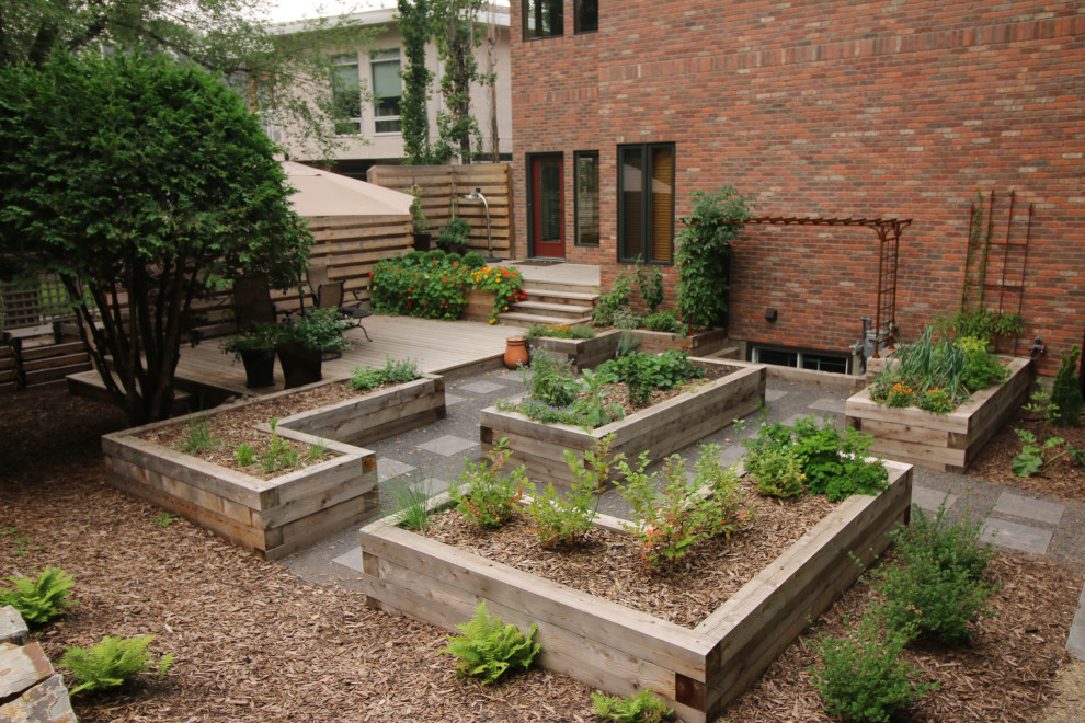 Inspiration for a mid-sized traditional backyard formal garden in Edmonton with with raised garden bed.
