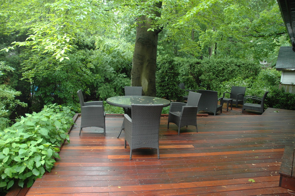 Inspiration for a large traditional partial sun backyard formal garden in Toronto with decking for spring.