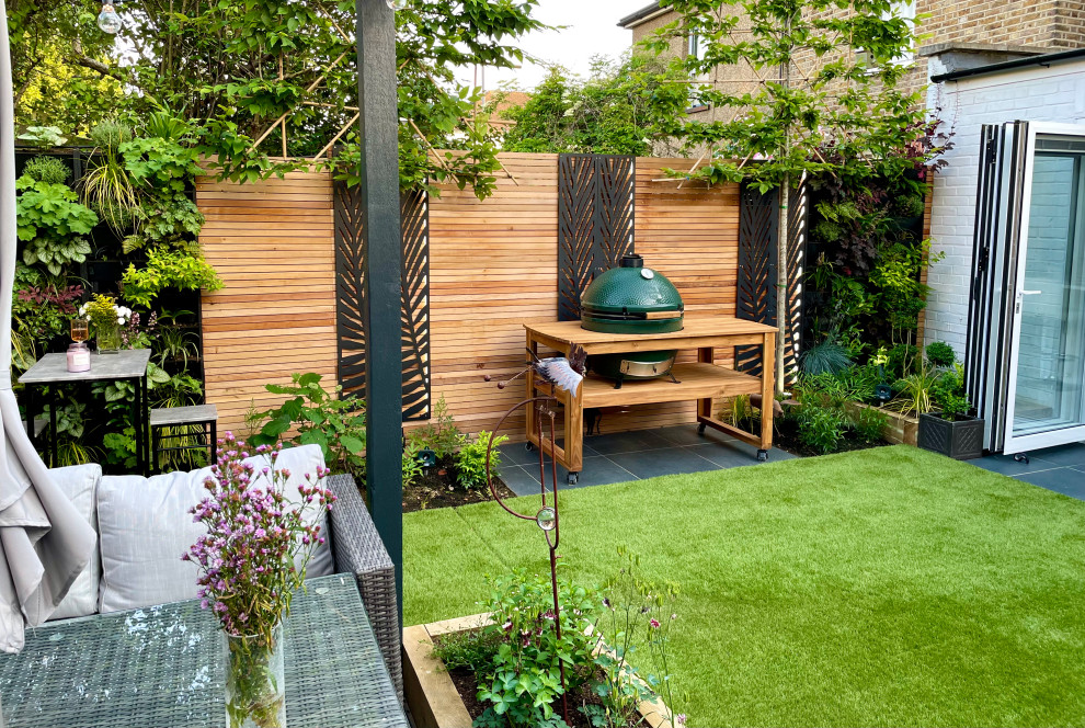 Photo of a mid-sized modern partial sun backyard landscaping in Other for summer.