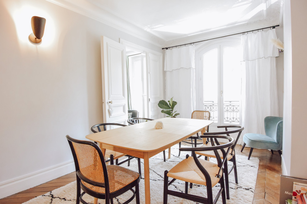 Photo of a mid-sized scandinavian separate dining room in Paris with grey walls, dark hardwood floors, brown floor and no fireplace.