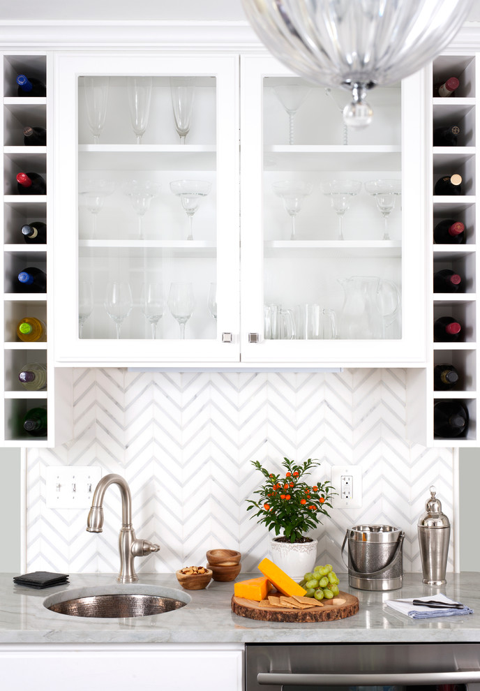 Design ideas for a small transitional galley wet bar in DC Metro with an undermount sink, glass-front cabinets, white cabinets, tile benchtops, white splashback, dark hardwood floors and brown floor.