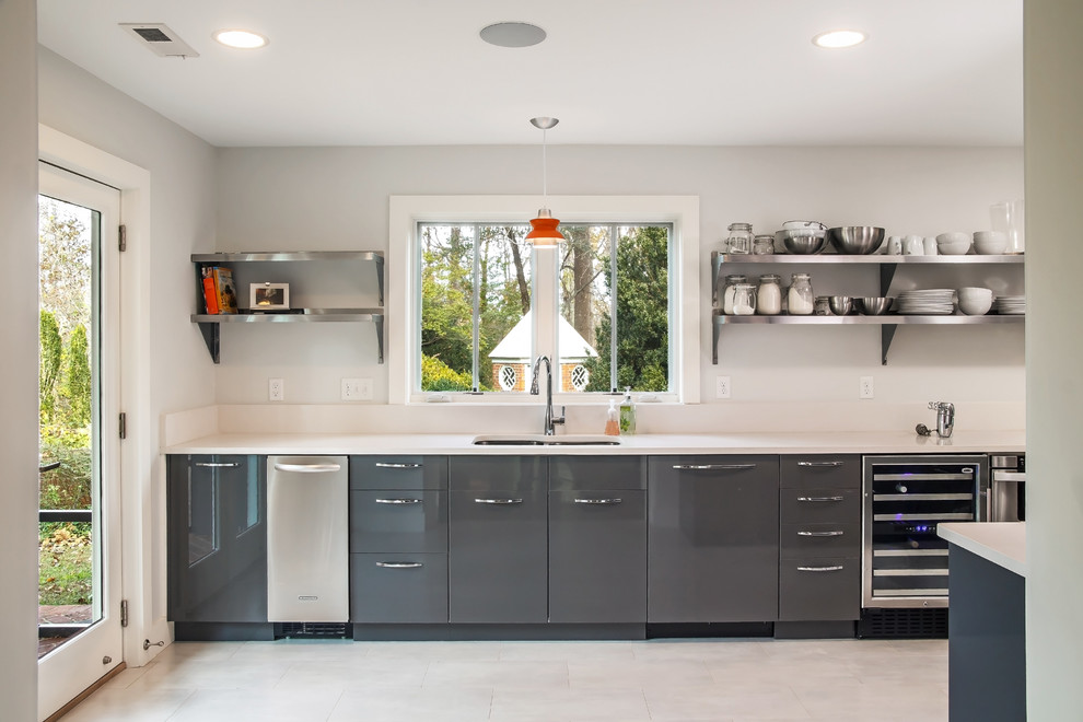 Design ideas for a mid-sized midcentury galley separate kitchen in DC Metro with an undermount sink, flat-panel cabinets, quartz benchtops, porcelain floors and grey cabinets.