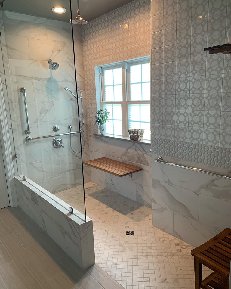 Example of a large transitional master white tile and porcelain tile porcelain tile and gray floor doorless shower design with shaker cabinets, gray cabinets, gray walls, an undermount sink, quartz countertops and white countertops
