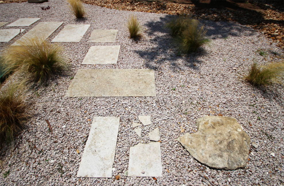 Inspiration for a large side garden in Austin with decorative stones.