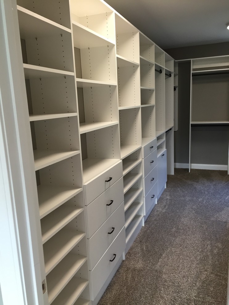 Photo of a small contemporary walk-in wardrobe in Other with flat-panel cabinets and white cabinets.