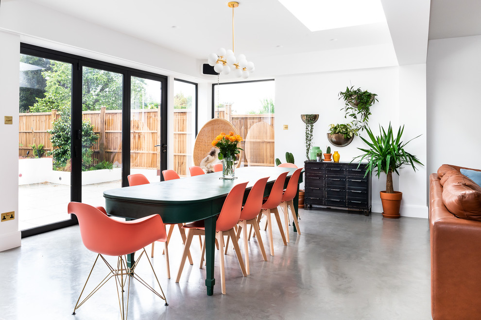 Design ideas for a large modern dining room in London with white walls, concrete floors, grey floor, recessed and brick walls.