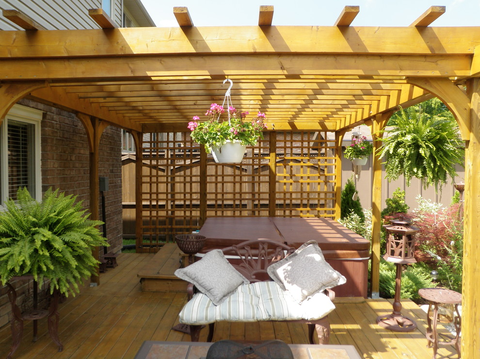 Mid-sized traditional backyard patio in Toronto with decking and a pergola.