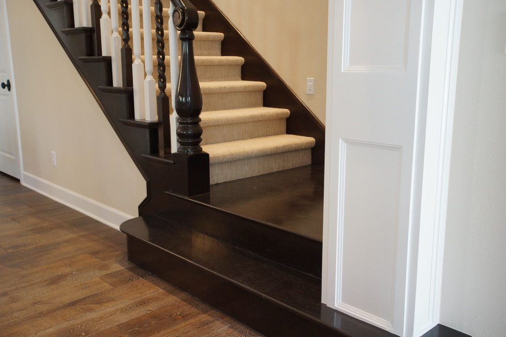 Large mediterranean carpeted straight staircase in San Diego with wood risers.