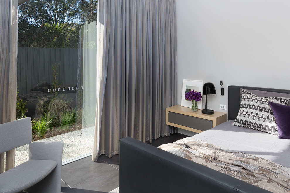 Inspiration for a modern master bedroom in Sydney with grey walls, porcelain floors and grey floor.
