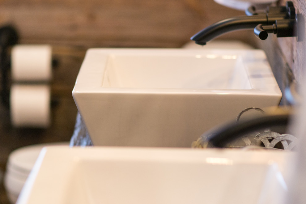 Example of a mountain style bathroom design in Toronto with wood countertops