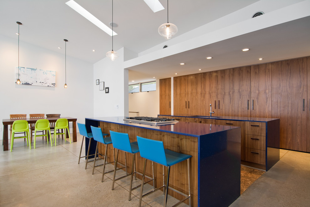 This is an example of a contemporary eat-in kitchen in Salt Lake City with flat-panel cabinets and blue benchtop.