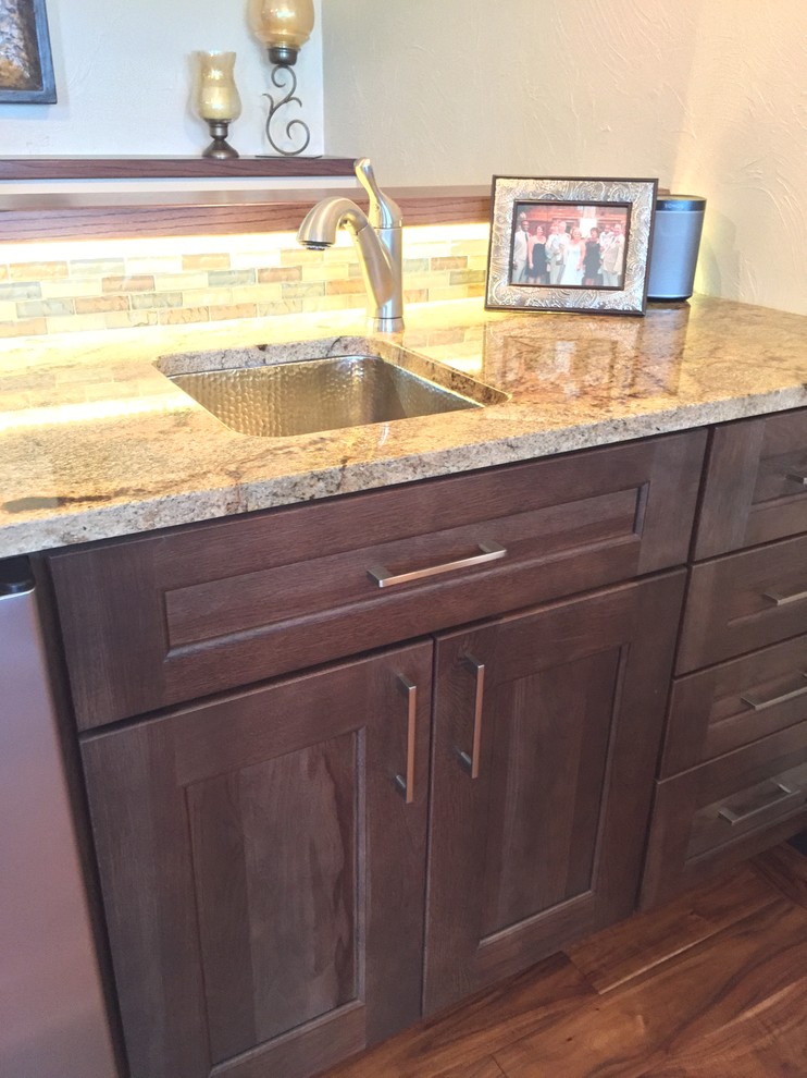 This is an example of a mid-sized transitional home bar in Omaha.
