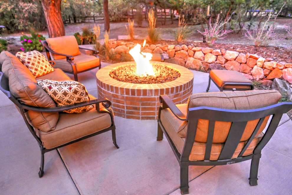 This is an example of a large traditional backyard patio in Denver with a fire feature, concrete slab and no cover.