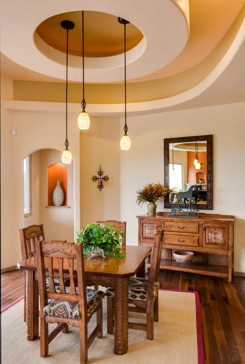 Inspiration for a mid-sized southwestern dark wood floor enclosed dining room remodel in Albuquerque with beige walls and no fireplace