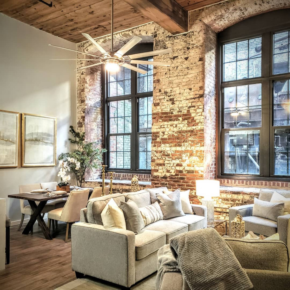 Photo of a small industrial loft-style living room in Atlanta with no fireplace, a wood fireplace surround and multi-coloured floor.