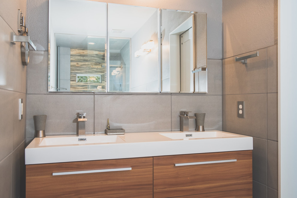 Inspiration for a mid-sized contemporary master bathroom in Other with flat-panel cabinets, medium wood cabinets, gray tile, grey walls, an open shower, white benchtops, a hot tub, an open shower, a one-piece toilet, a wall-mount sink and grey floor.