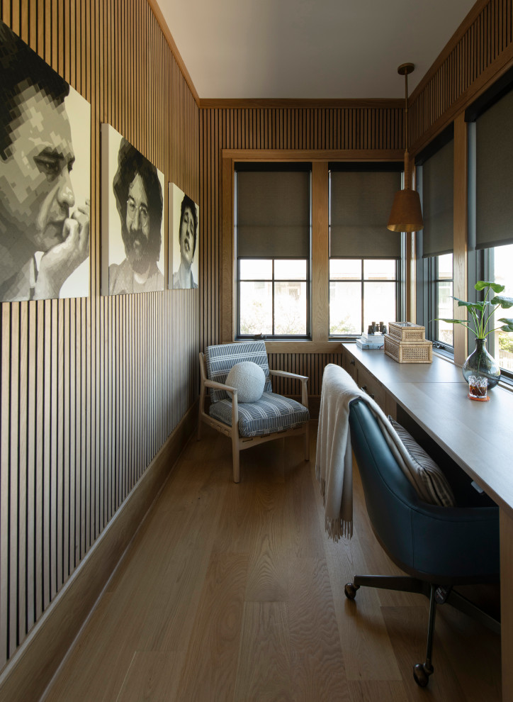 Inspiration for a coastal built-in desk medium tone wood floor, brown floor and wood wall home office remodel in Other with brown walls