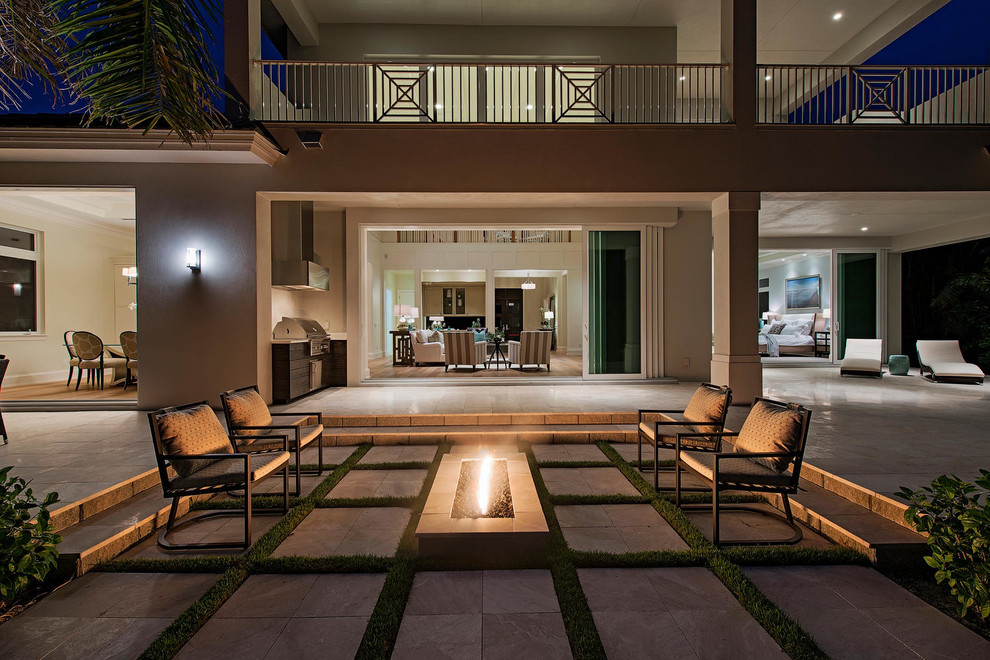 Island style patio photo in Miami with a fire pit and no cover