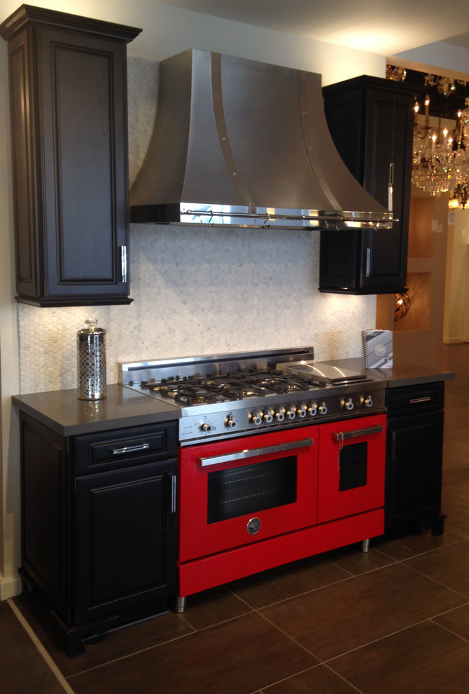 Inspiration for a transitional porcelain tile kitchen remodel with raised-panel cabinets, black cabinets, quartz countertops, gray backsplash, stone tile backsplash and colored appliances