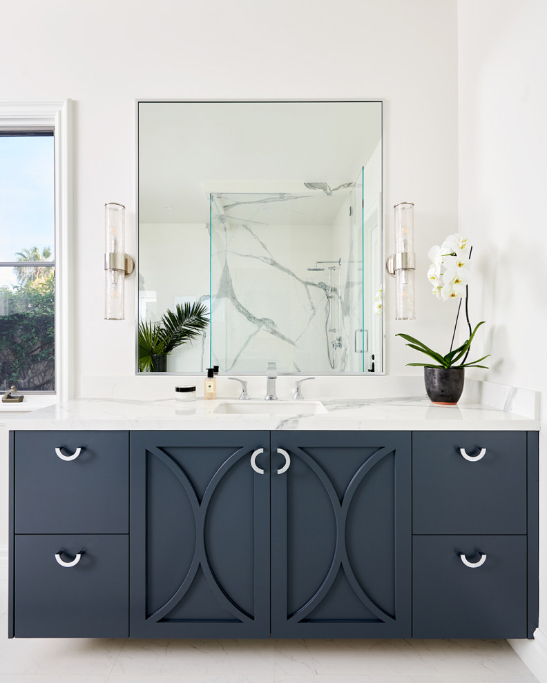 Design ideas for a large transitional master bathroom in Los Angeles with furniture-like cabinets, blue cabinets, a freestanding tub, a corner shower, white tile, quartzite benchtops, white floor, a hinged shower door, white benchtops and an enclosed toilet.
