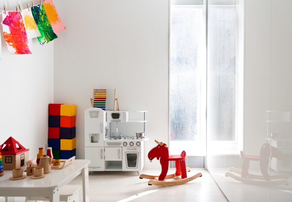 Design ideas for a scandinavian gender-neutral kids' room in New York with white walls.