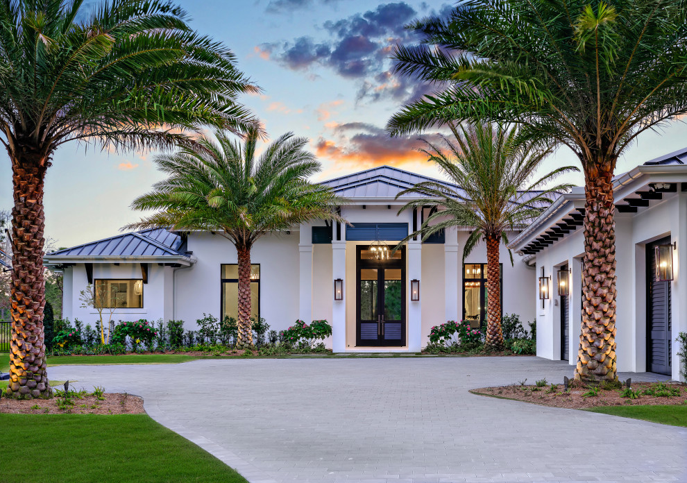 Photo of an expansive transitional one-storey stucco white house exterior in Miami with a hip roof, a blue roof and a metal roof.