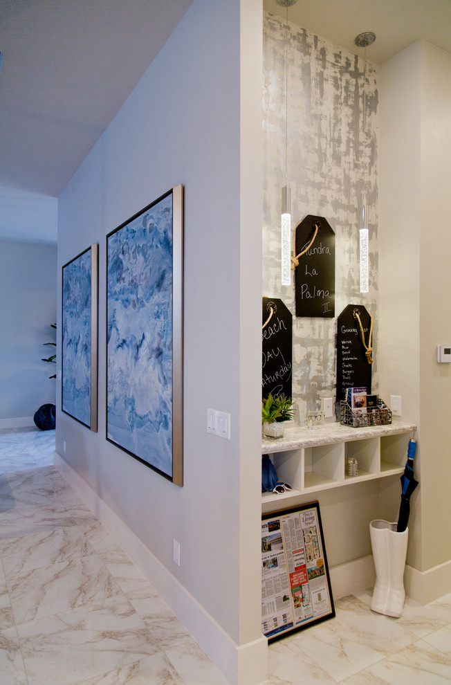 This is an example of a mid-sized transitional hallway in Miami with beige walls, ceramic floors and multi-coloured floor.