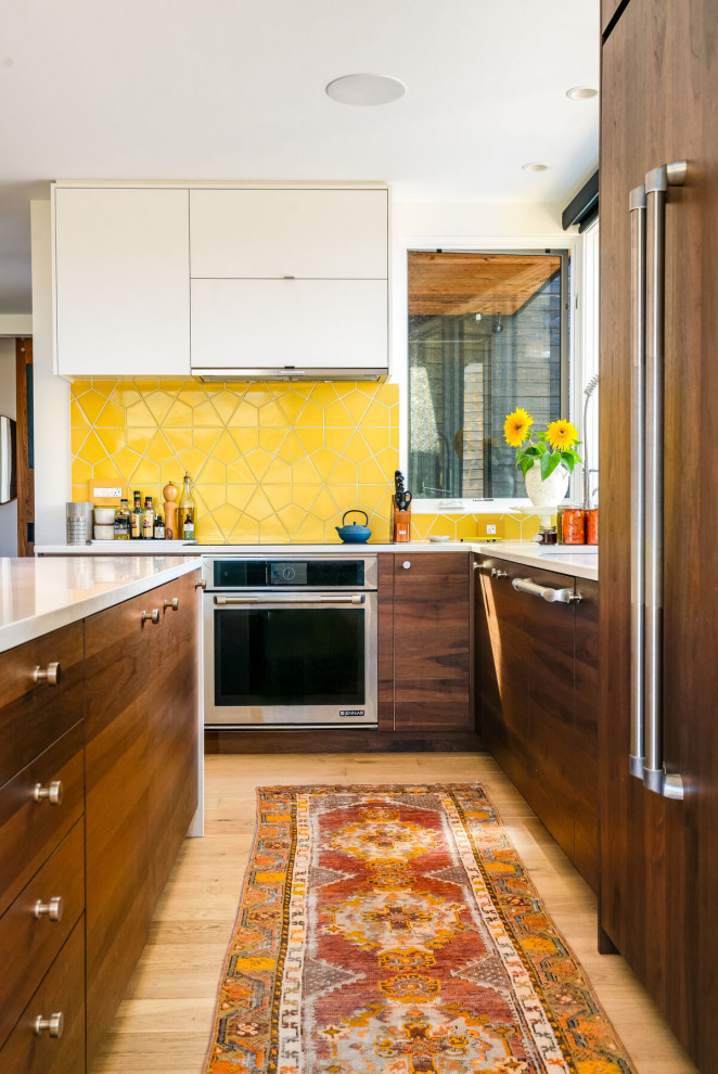 Photo of a midcentury kitchen in Seattle with yellow splashback and ceramic splashback.