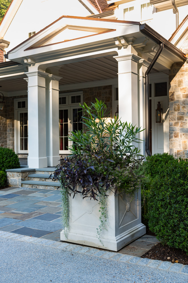 Inspiration for a large traditional front yard partial sun driveway in Atlanta with natural stone pavers.