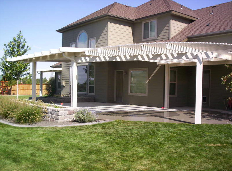 Inspiration for a small transitional side yard deck remodel in Boise with a roof extension