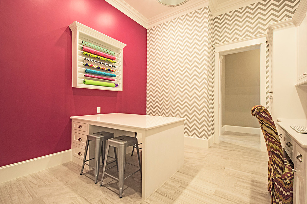 Mid-sized transitional craft room in Dallas with medium hardwood floors, a built-in desk and multi-coloured walls.
