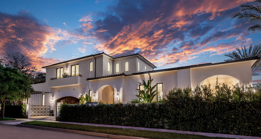 Large tuscan white two-story stucco and shingle exterior home photo in Los Angeles with a shingle roof and a red roof