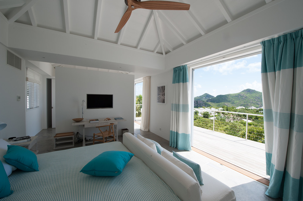 Photo of a tropical bedroom in Other with white walls.