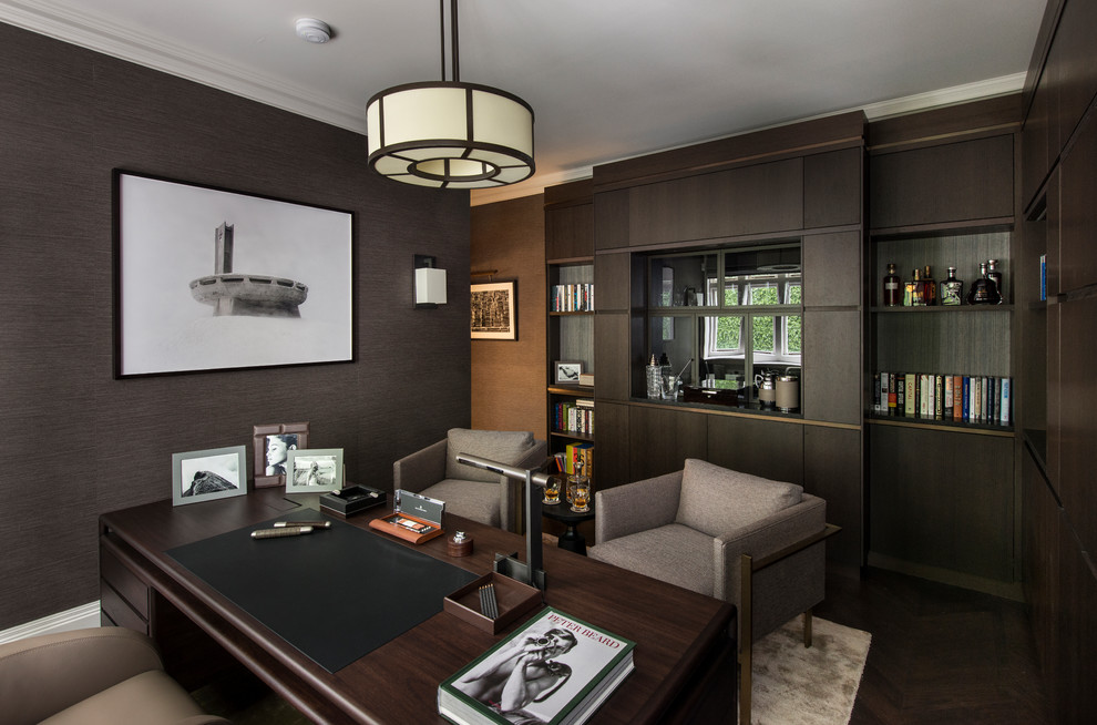 Mid-sized transitional home office in London with dark hardwood floors, a freestanding desk and brown floor.