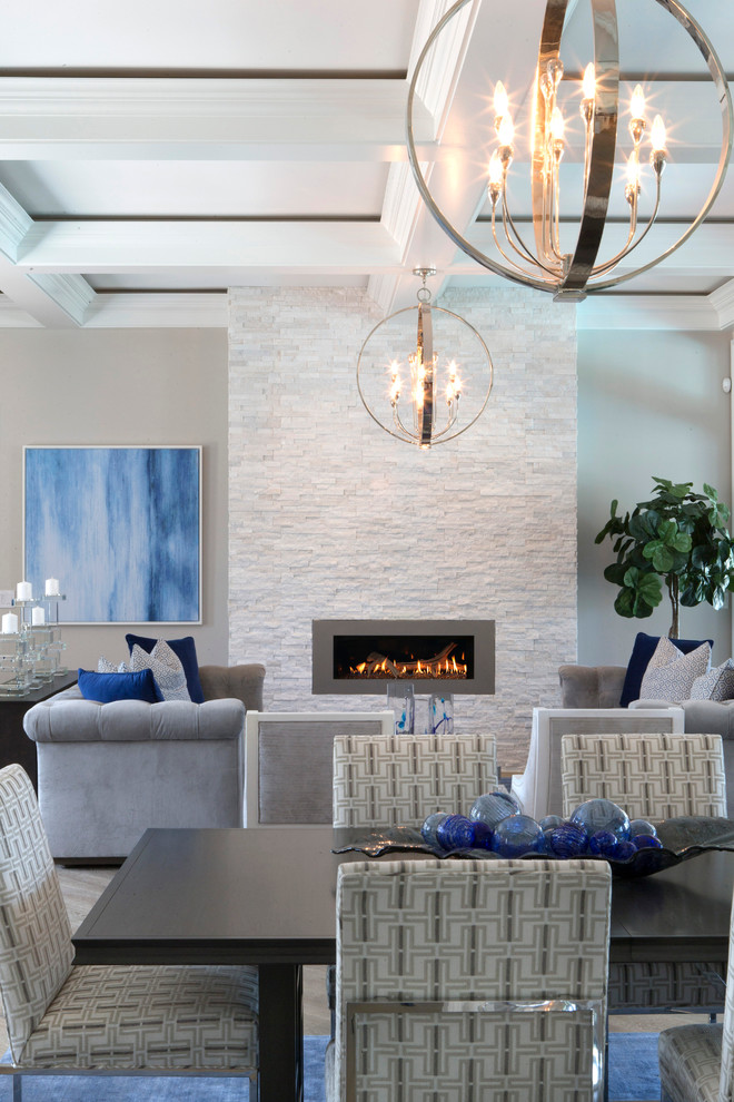 Design ideas for a large contemporary open plan dining in Miami with grey walls and a stone fireplace surround.