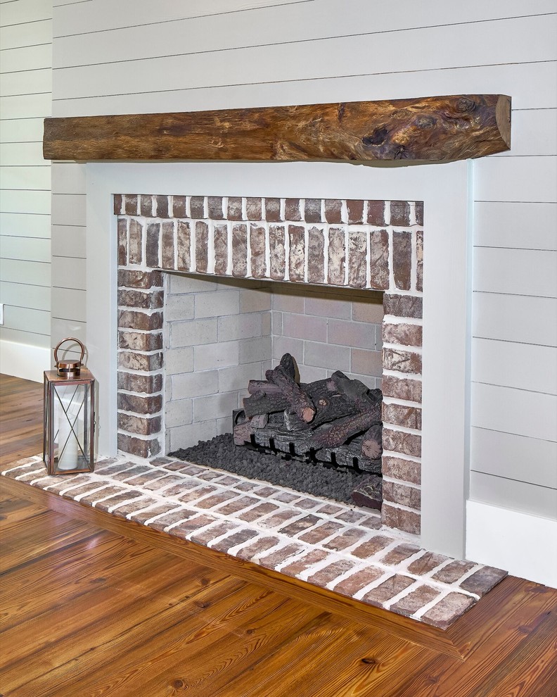 Mid-sized transitional formal and enclosed medium tone wood floor living room photo in Atlanta with gray walls, a standard fireplace and a brick fireplace