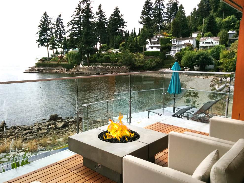 Patio - transitional backyard patio idea in Vancouver with a fire pit