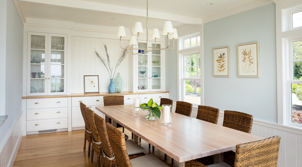 Inspiration for a beach style separate dining room in Providence with blue walls, medium hardwood floors and brown floor.