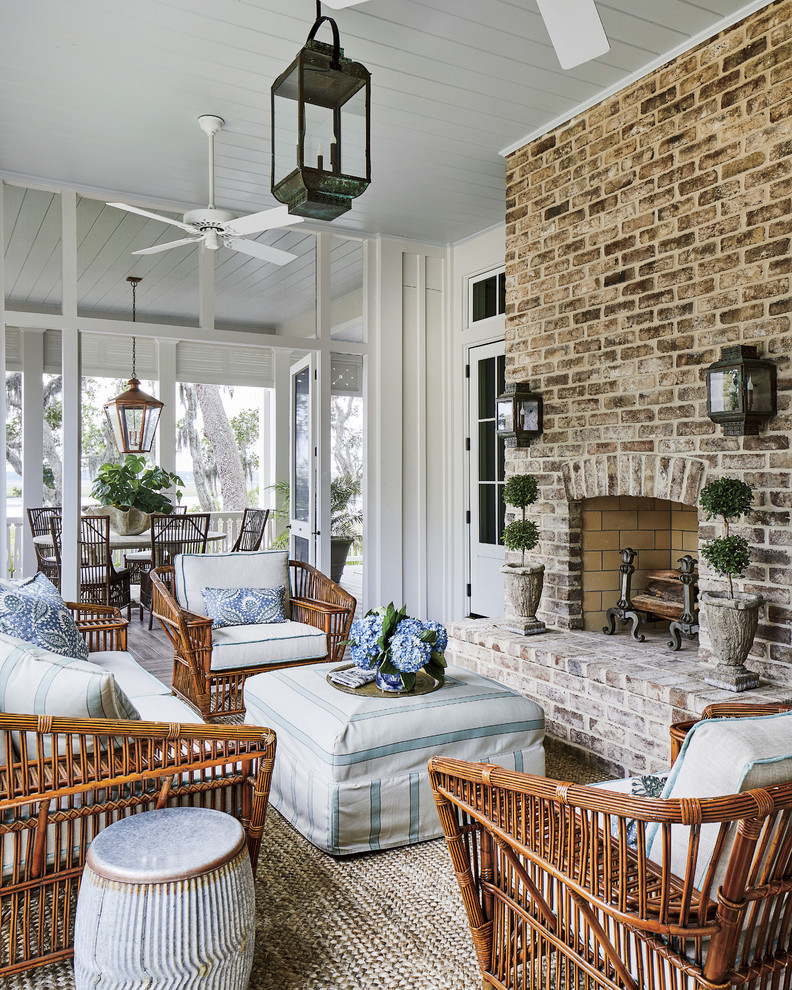 Photo of a beach style sunroom in Jacksonville with a standard fireplace, a brick fireplace surround and a standard ceiling.