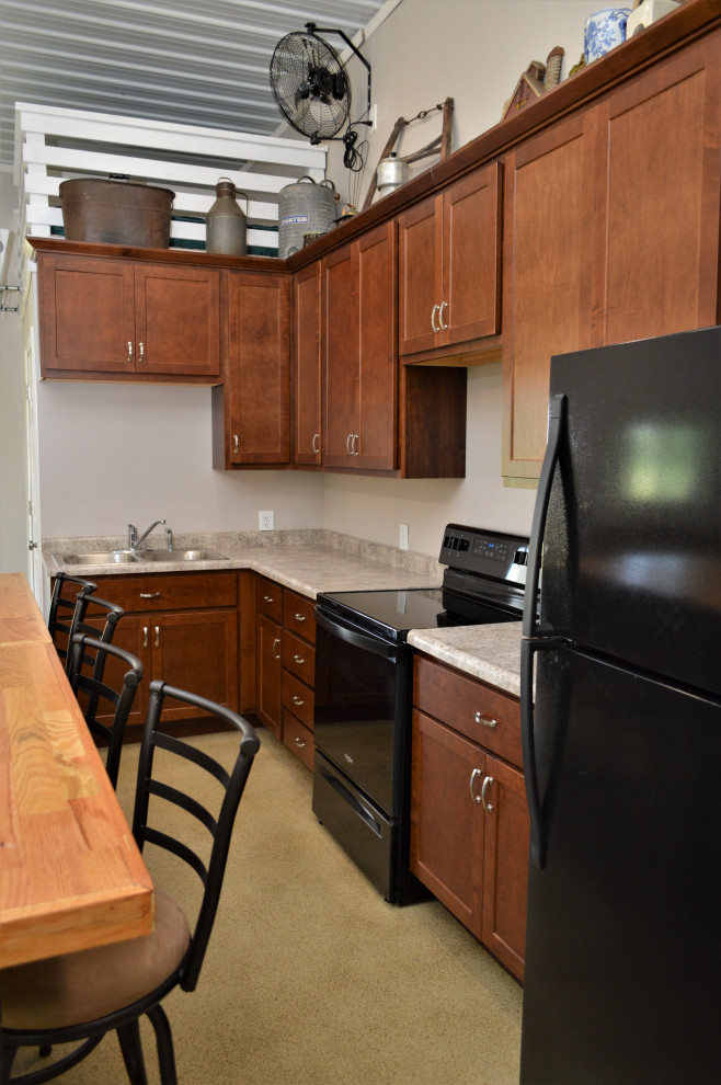 Inspiration for a mid-sized transitional l-shaped cement tile floor and yellow floor open concept kitchen remodel with a drop-in sink, shaker cabinets, brown cabinets, wood countertops, brown backsplash, black appliances, an island and brown countertops