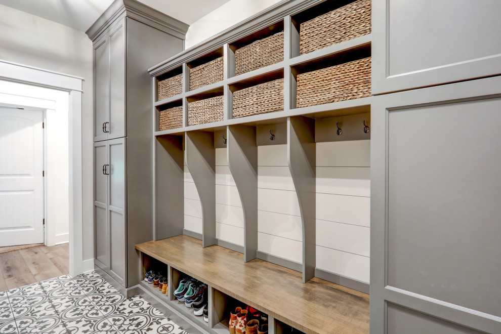 Inspiration for a large country utility room with grey cabinets, ceramic flooring and multi-coloured floors.