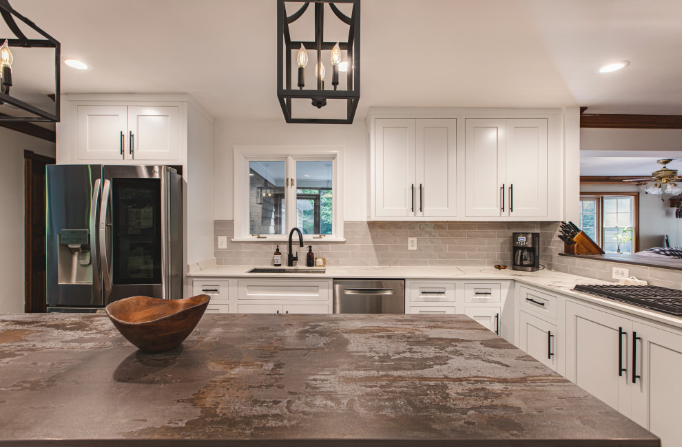 Example of a large country l-shaped cement tile floor and gray floor eat-in kitchen design in DC Metro with a single-bowl sink, shaker cabinets, distressed cabinets, quartz countertops, gray backsplash, ceramic backsplash, stainless steel appliances, an island and brown countertops