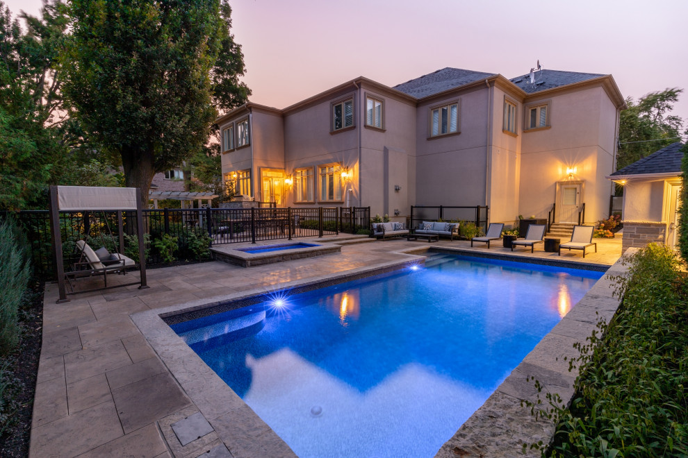 Pool landscaping - mid-sized transitional backyard stamped concrete and rectangular pool landscaping idea in Toronto