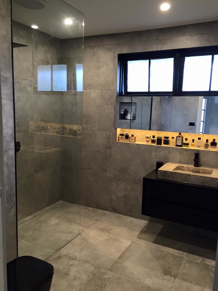 Mid-sized industrial master bathroom in Melbourne with black cabinets, an open shower, a one-piece toilet, gray tile, cement tile, grey walls, cement tiles and a vessel sink.