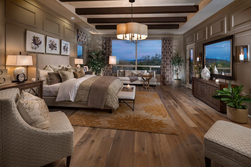 This is an example of a mediterranean master bedroom in Phoenix with grey walls and dark hardwood floors.