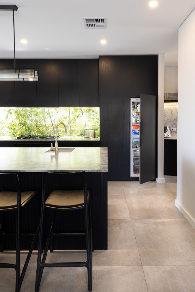 Design ideas for a large contemporary galley eat-in kitchen in Perth with an undermount sink, marble benchtops, multi-coloured splashback, marble splashback, coloured appliances, porcelain floors, with island, grey floor, multi-coloured benchtop and black cabinets.
