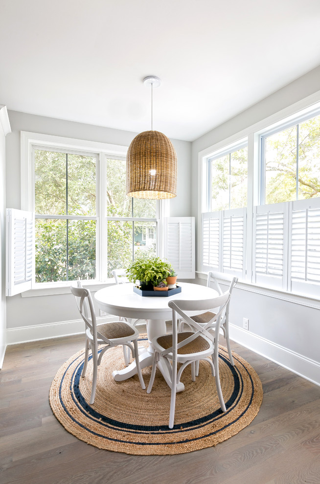 Design ideas for a small beach style dining room in Charleston with grey walls, light hardwood floors and no fireplace.